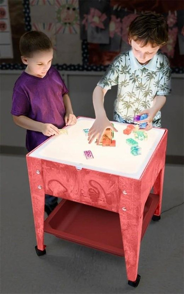 Childbrite Illumi Mite Light Table Kit Add On for Sensory Tables, children playing with illuminated colorful toys on a red sensory table in a classroom setting.