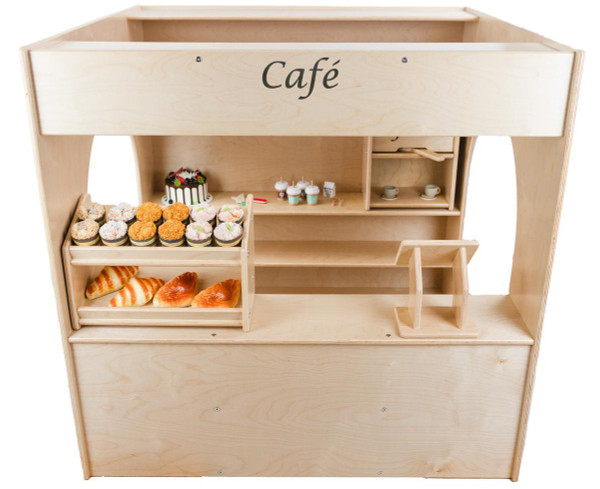 Wood Designs Town Collection Café Playhouse, wooden playhouse with shelves and a counter showcasing mini cupcakes, bread, and miniature coffee cups designed for children's pretend play.
