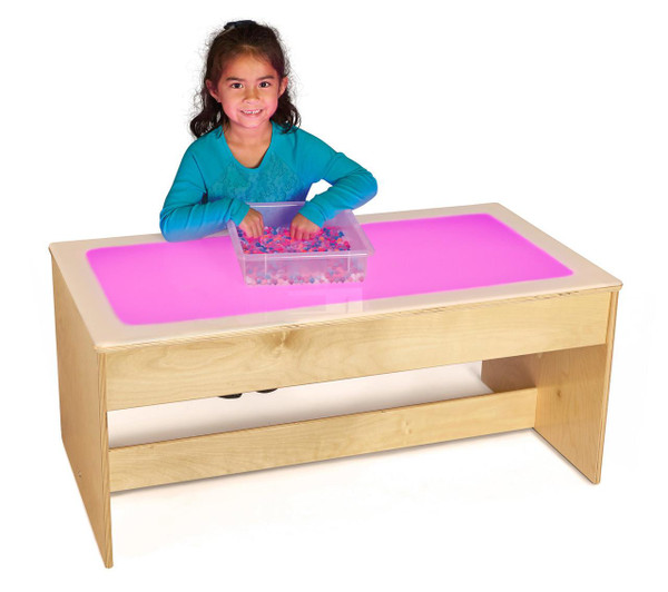 Jonti-Craft Large Light Table - Multicolored, wooden light table with multicolored illuminated surface and a transparent container filled with small colorful objects, used for educational and sensory activities for children.