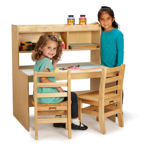 Jonti-Craft Dual Writing Desk, Wooden children's study desk with two chairs and multiple storage shelves for kids' art supplies and books.