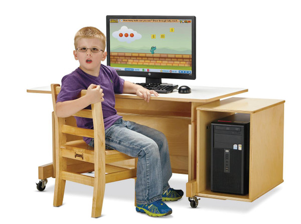 Jonti-Craft Apollo Single Computer Desk, White Top, with a young boy sitting on a wooden chair in front of a computer monitor and desktop computer underneath, in a classroom or home office setting.