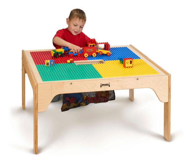 Jonti-Craft Wooden Kids DUPLO® Square Storage Table, a wooden table with a colorful LEGO DUPLO® set on top and a child playing with the toys.