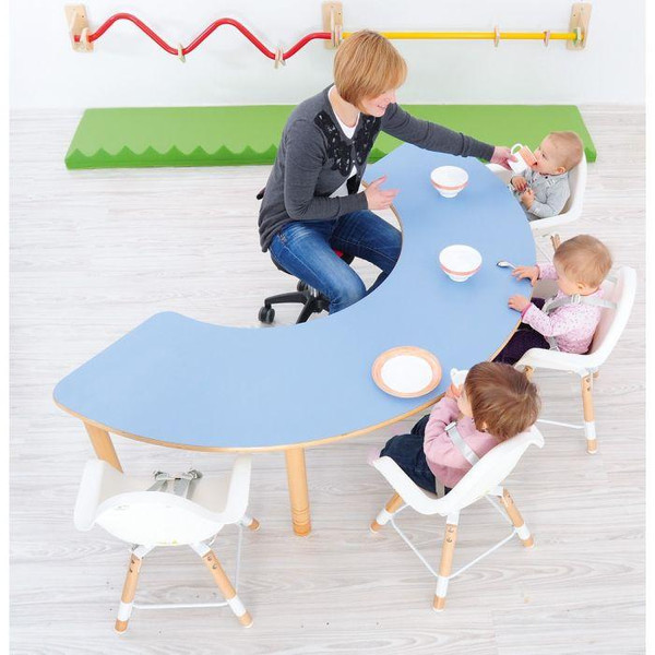Moje Bambino Curved Horseshoe Table, blue curved preschool activity table with a horseshoe-shaped design, shown with a teacher and young children during a classroom activity.