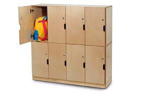 Whitney Brothers Backpack Lockable Storage, wooden storage unit with multiple compartments and a partially open door revealing a colorful backpack inside.