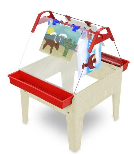Childbrite Toddler Basic Art Easel - Multiple Colors, a children's art easel with a sturdy white base, red sides, and a transparent acrylic writing surface with colorful clips holding up children's artwork.