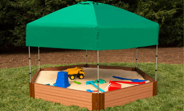 Frame It All Hexagon Sandbox with Telescoping Canopy & Cover - 7' x 8' x 11", backyard sandbox featuring a green telescoping canopy over a hexagonal wooden sandbox filled with sand and toys.