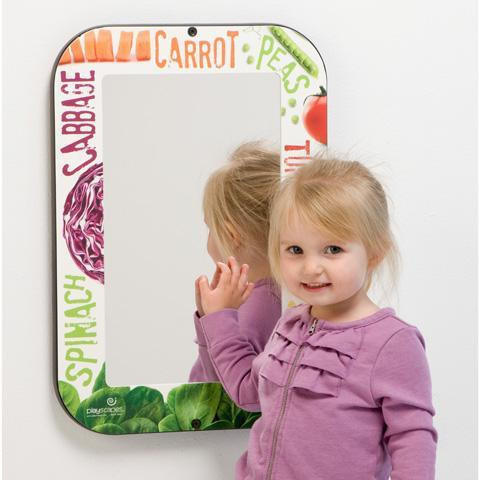 Playscapes Veggie Children's Fun Mirror, a decorative mirror with colorful vegetable illustrations including carrot, peas, cabbage, and spinach around the frame, featuring a young girl smiling and touching the mirror.