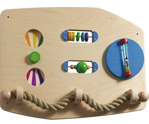 HABA Pro Motor Skills D Sensory Learning Wall Panel, wooden sensory wall toy with colorful rotating and sliding elements for fine motor skill development.