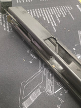 The trip bar is pulled forward by the bolt face, when a round is chambered the trip bar is simultaneously pulling forward on the SS arm allowing the trigger to be pulled.