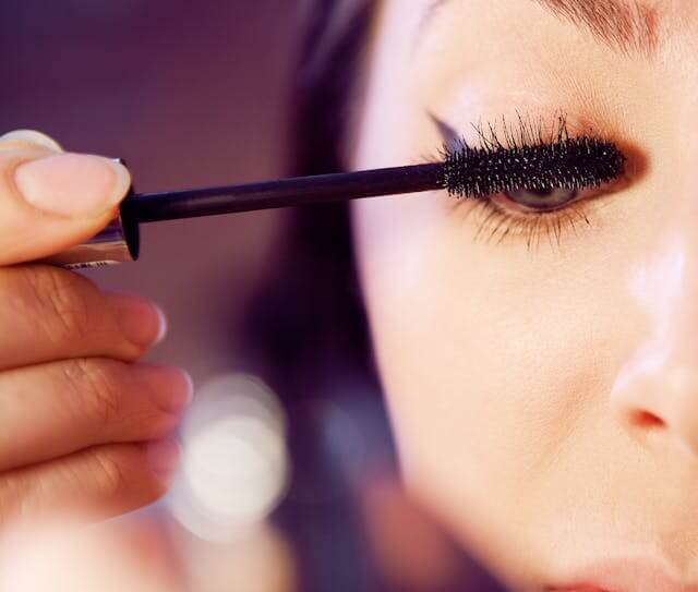 Woman applying waterproof mascara