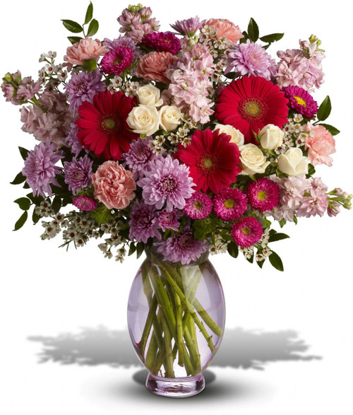 A perfectly pleasing mix of sweet springtime blossoms make this a truly happy gift. So full of feminine flowers and fun feelings, this is the perfect arrangement to make her smile.