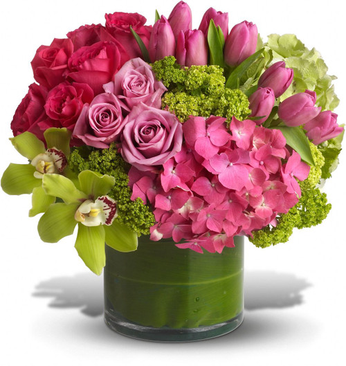 Upscale and uptown. This fantastic arrangement is a beauty and a half to behold. Overflowing with gorgeous blossoms and delivered in a leaf-lined cylinder vase, it's truly a floral fantasy.