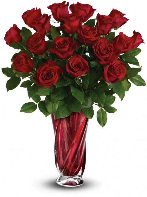 This Valentine's Day, surprise her with a gift as radiant as she is - 18 long stem red roses, hand-delivered in a stunning, ruby red art glass vase. It's sure to take her breath away!  Actual vase may vary but will be a high-end keepsake vase