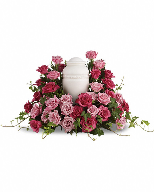 Surrounded by roses, enveloped in love - a sumptuous pink rose wreath of light and dark hues serves as a stunning memorial.
Features thirty five light and hot pink roses with trailing stems of lush green ivy.Please note: Arrangement does not include urn