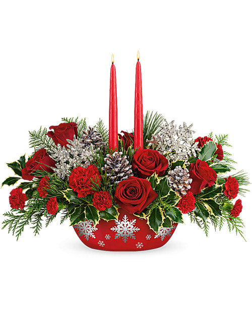 Make the winter's eve table shine with this festive candlelit centerpiece of radiant red roses and winter greens, artfully arranged inside a hand-glazed, oven-to-table ceramic serving dish that shimmers with swirling silver snowflakes!  Make the winter's eve table shine with this festive candlelit centerpiece of radiant red roses and winter greens, artfully arranged. Deluxe and Premium use more roses for a bigger splash.