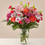 The Light of My Life Bouquet blossoms with brilliant color and a sweet sophistication to create the perfect impression! Pink Lilies make the eyes dance across the unique design of this flower bouquet, surrounded by the blushing colors of orange roses, lavender cushion poms, hot pink carnations, and lush greens. Presented in a clear glass vase, this fresh flower arrangement has been created just for you to help you send your sweetest Mother's Day, thank you, happy anniversary, or thinking of you wishes.