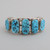 Bold sterling silver cuff with open work on the sides and large nugget Turquoise stones.