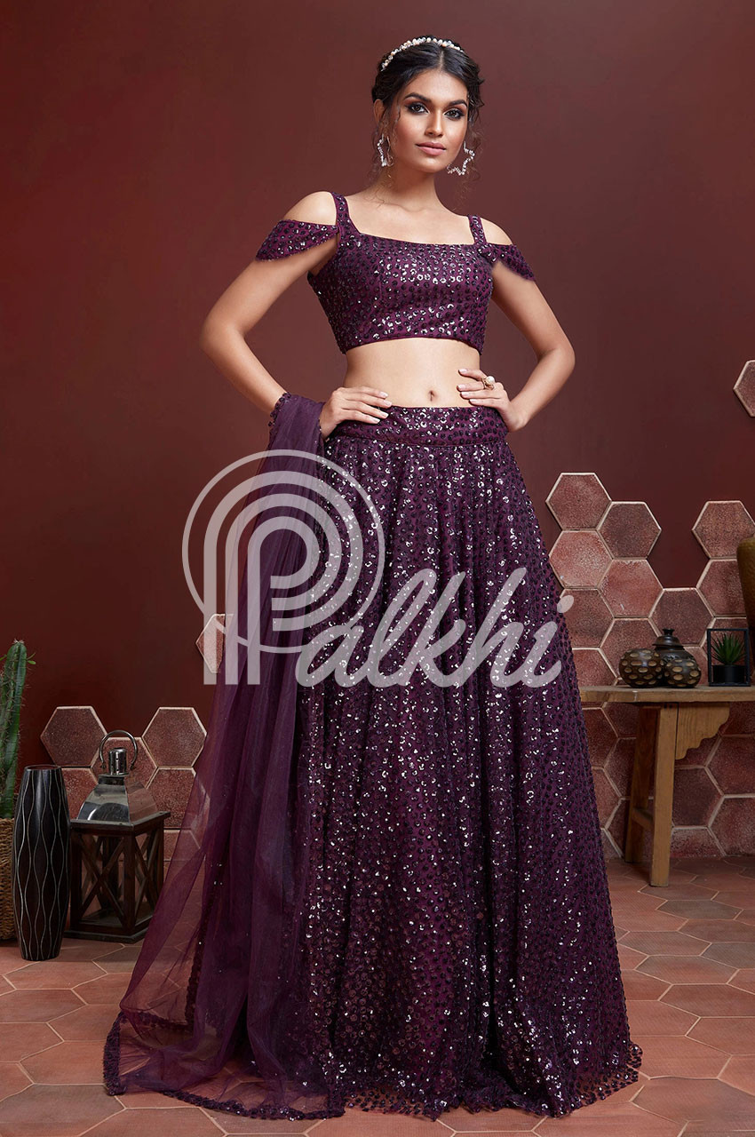 Photo of Couple portrait of a bride in aubergine lehenga and a groom in  black bandhgala.