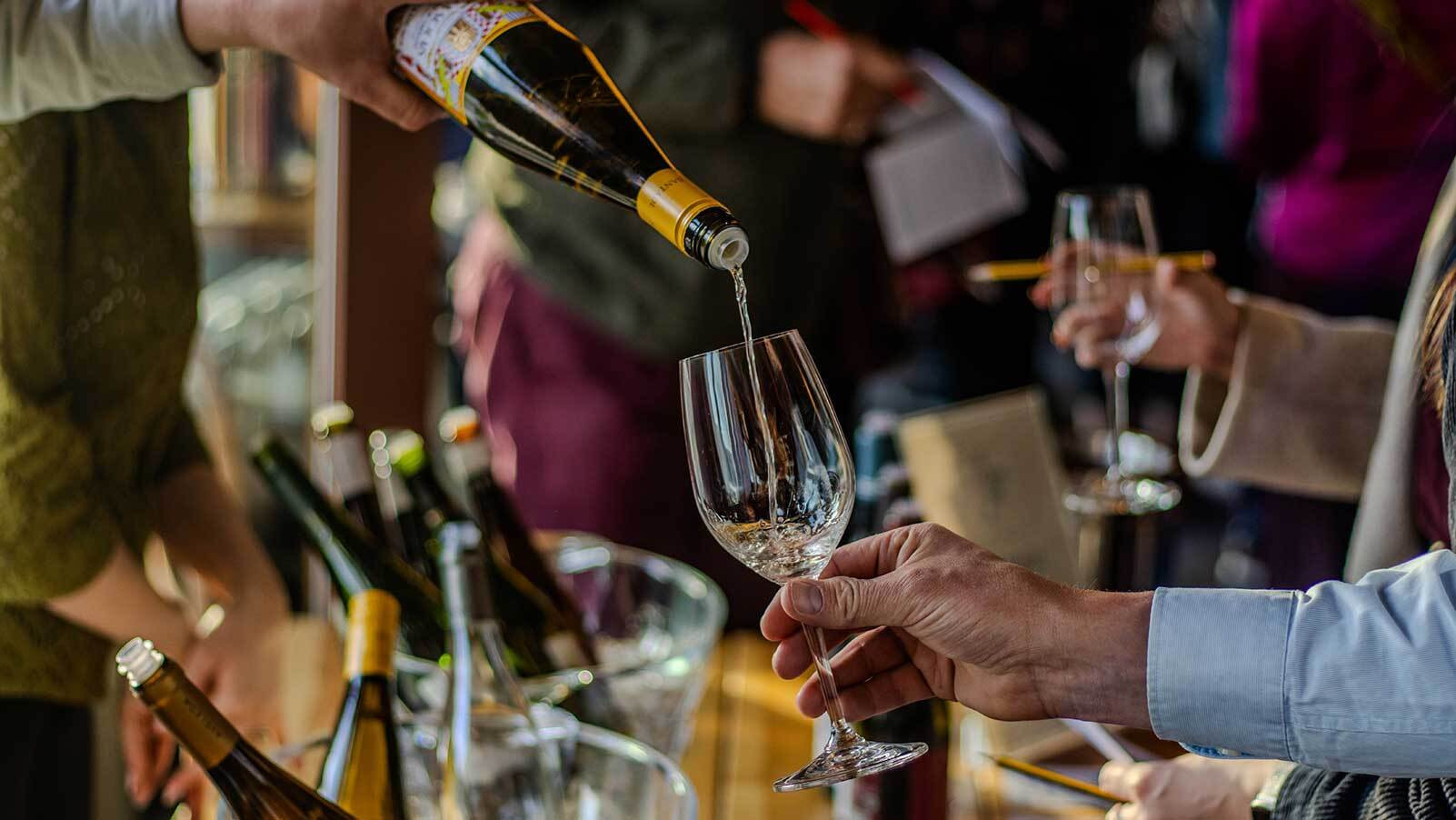 An image showing a tasting sample being poured into a glass at one of our events