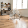20 inch chrome floor fan standing on wooden floor in a large bright open plan living space