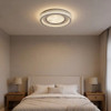 Round LED flush ceiling light 80cm in chrome, dimmable with remote, shown in a modern bedroom