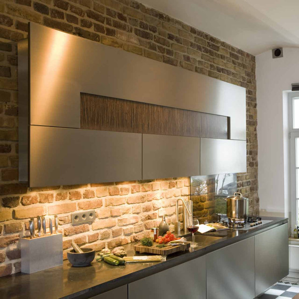 Set of 6 LED mini downlights installed under kitchen cabinets with warm white light