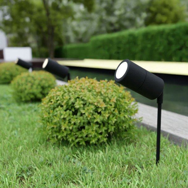IP65 outdoor garden spike light with adjustable head installed on lawn and pathway, GU10 compatible