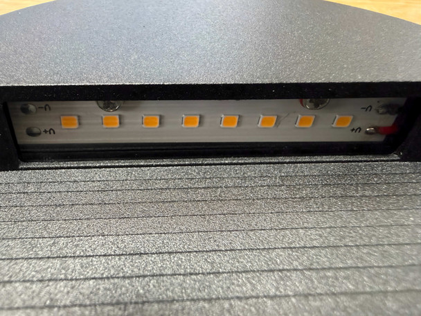 Warm white 3000K SMD LED strip inside round black outdoor step light