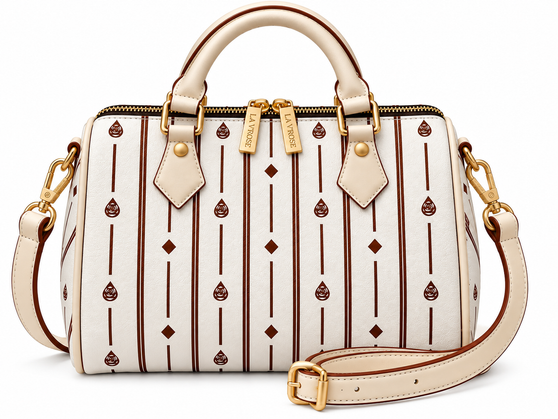 Signature pattern meets timeless structure. The Flori™ Grand Pebble features a spacious Boston silhouette finished with polished gold-tone hardware and versatile carry options.