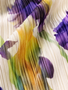 This sleeveless pleated dress features a striking oversized iris floral print that brings timeless sophistication to every occasion. Designed with lightweight chiffon fabric, it drapes beautifully while offering comfortable movement and a flattering silhouette.