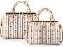 Signature pattern meets timeless structure. The Flori™ Grand Pebble features a spacious Boston silhouette finished with polished gold-tone hardware and versatile carry options.