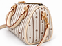 Signature pattern meets timeless structure. The Flori™ Grand Pebble features a spacious Boston silhouette finished with polished gold-tone hardware and versatile carry options.