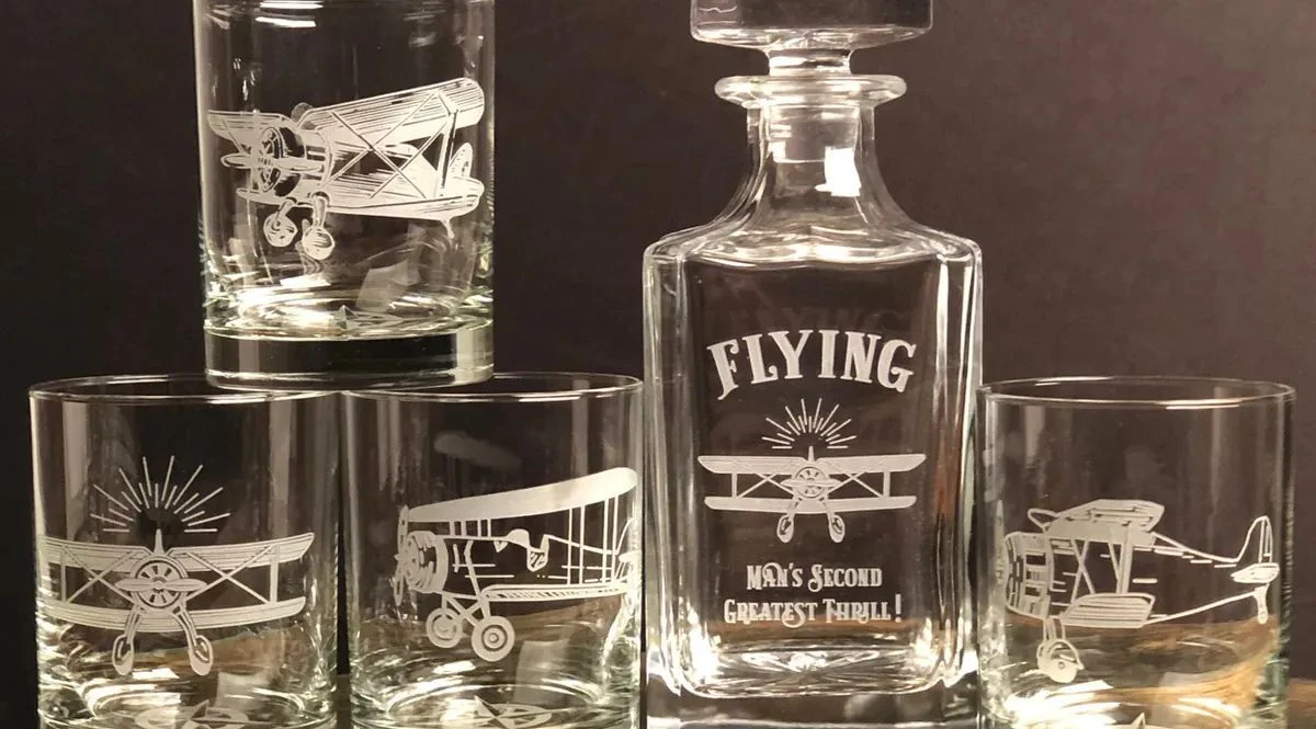 Sandblasted whiskey decanter and glasses engraved with vintage biplanes