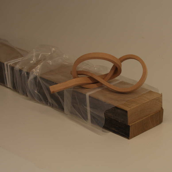 Compressed wood ships wrapped in plastic to retain its moisture at ~20%.