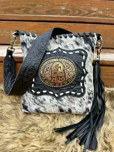 Black and white speckled buckle bag with buck stitched black floral leather accent and black fringe