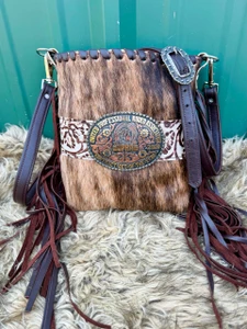 Brindle cowhide buckle bag with cream floral accents and chocolate leather fringe
