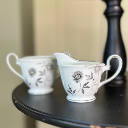 Vintage Noritake Rosamor cream and sugar set featuring white porcelain with black floral detailing and platinum trim, including creamer and sugar bowl without lid, discontinued collectible china made in Japan.