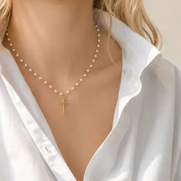 Cabled Cross Pendant Necklace featuring an 18K gold-plated cable-textured cross on a luminous glass pearl chain with an adjustable 16-inch necklace and 2-inch extender.