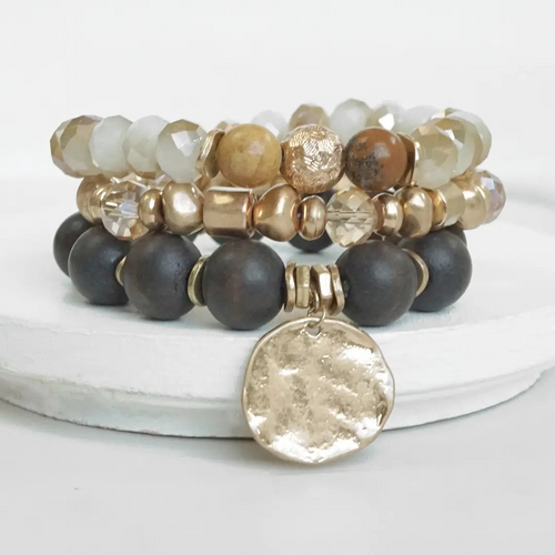 Brown boho beaded bracelet stack with hammered gold-tone coin charms