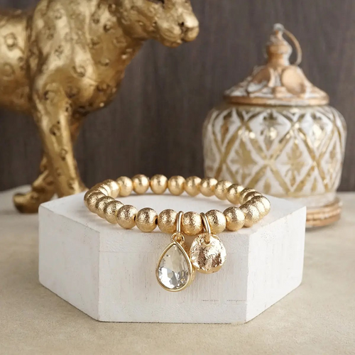 Gold statement chain bracelet with brilliant faceted crystal charm