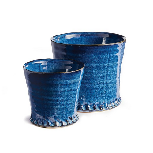 Enhance your home decor with this Italian-inspired set of pots, featuring a classical body and thick glaze. Hand-finished details add an artisan's touch. Ideal for lush green plants or orchids, use as cachepots or plant directly. Protect furniture by lining the interior and safeguard from frost. Dimensions: 6.5 x 6.5 x 5 inches and 4.75 x 4.75 x 4 inches. Available in blue with drain holes.