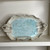 Handcrafted ruffle edge platter in soft cream and blue glaze with decorative handles