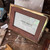 Elegant gold trimmed leather 4x6 picture frame with rich leather finish and adjustable gold metal stand, designed for tabletop display of family photos, wedding portraits, and keepsakes; timeless luxury home décor frame for shelves, desks, and bedside tables.