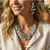 Turn heads with the handmade Atasi Statement Necklace, featuring soft pastel blue glass crystal beads woven through multi-strand vintage gold silk rope for an effortlessly elegant layered look. This lightweight chunky necklace is the perfect accessory for spring and summer outfits, bridal events, beach vacations, brunch, and everyday elevated style. Designed for women who love artisan jewelry, unique statement necklaces, and timeless boutique fashion, this handcrafted piece adds sophisticated texture and color to dresses, linen tops, and casual denim looks alike.