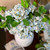Bundle of three blue real touch hydrangea blooms with a realistic green leaf stem arranged in a decorative vase, featuring lifelike petals and classic Southern-inspired home décor styling.