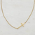 Kayla Side Cross Necklace in 18K gold-plated stainless steel featuring a delicate sideways cross on an adjustable chain.