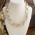 Textured gold and silver chain links on an asymmetrical statement necklace