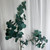 38.5” realistic faux eucalyptus stem with soft silvery-green leaves and natural veining, styled in a vase for elegant farmhouse home décor, lifelike artificial greenery for year-round arrangements and interior styling.