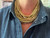 layered-beaded-collar-necklace-matte-gold-worn.jpg

Worn Zenzii metallic and crystal collar necklace in matte gold, statement jewelry on neckline