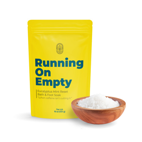 Running Empty bath soak pouch with bowl of mineral bath salts on white background